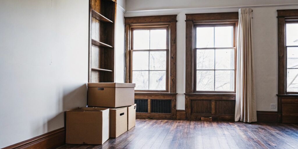 Partially empty Toronto apartment with moving boxes, prepared for deep cleaning before a major life change
