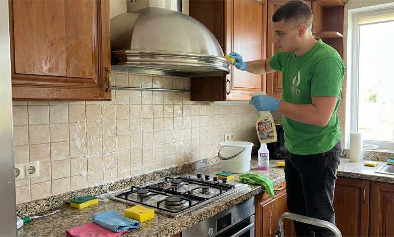 Zenvy technician deep cleaning kitchen range hood and backsplash in Toronto home