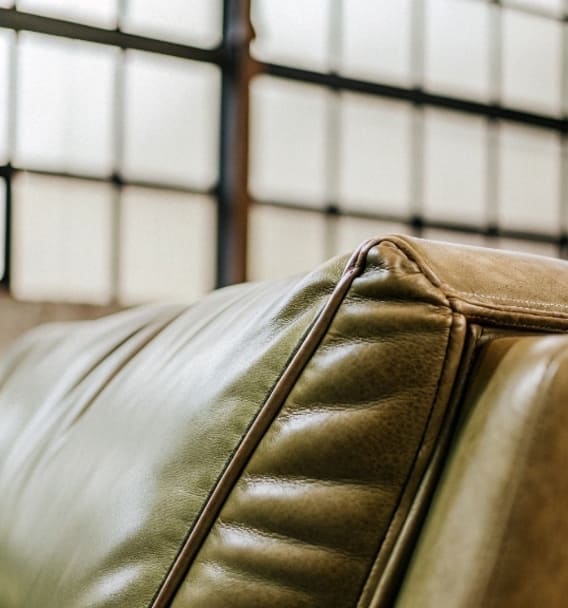 Close-up of leather sofa upholstery stitching and texture, ideal for professional leather couch cleaning in Toronto.