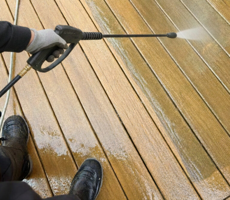 High-pressure water jet cleaning a deck surface to restore wood appearance in Toronto GTA.