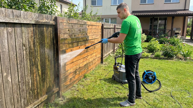 Wood fence power washing service in Toronto showing before and after results