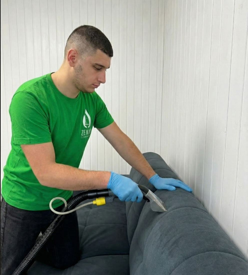 Zenvy technician cleaning a sofa