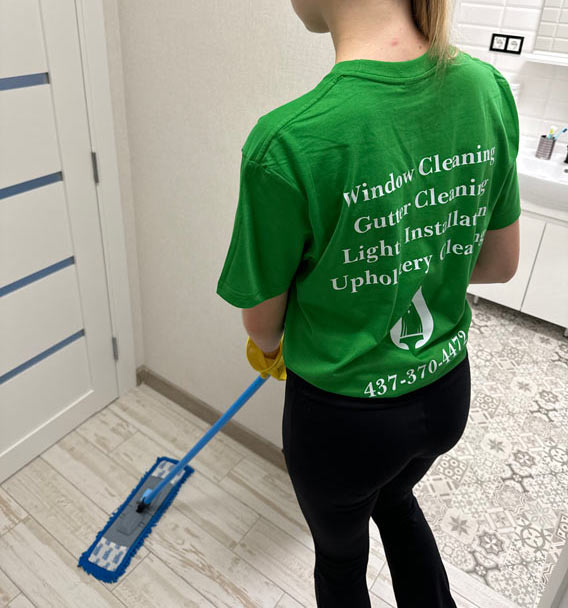 Zenvy cleaning professional mopping a tiled bathroom floor with a flat mop - professional house cleaning services across the Greater Toronto Area